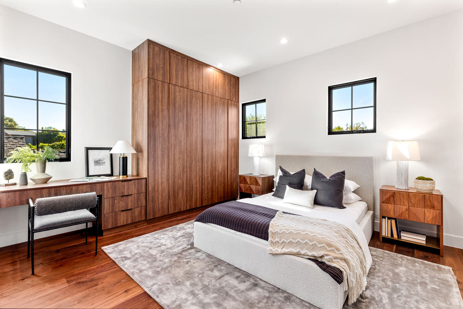 Los Angeles bedroom with a wood feature wall and upholstered bed