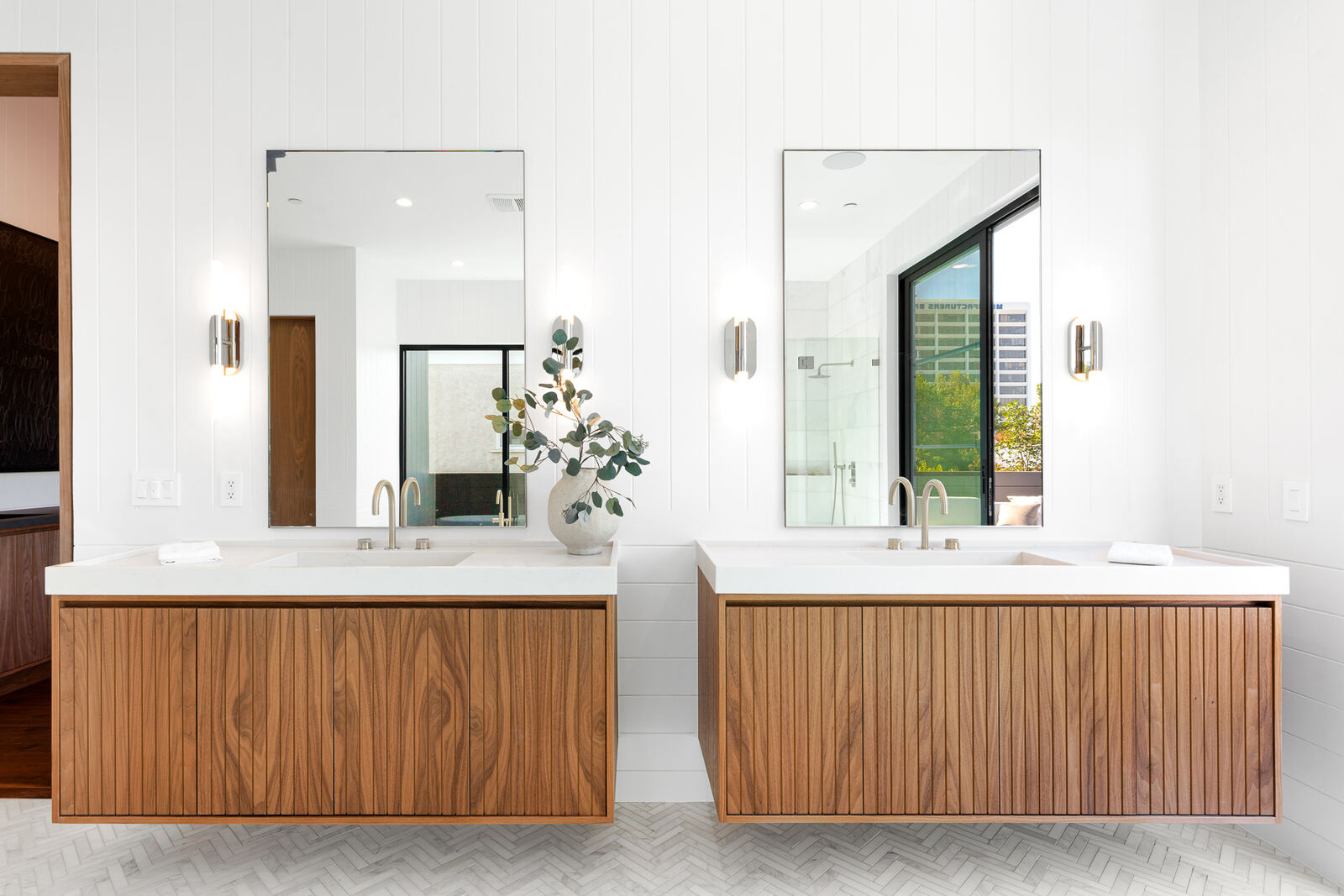 Double wood vanity with mirrors in a bright Los Angeles bathroom