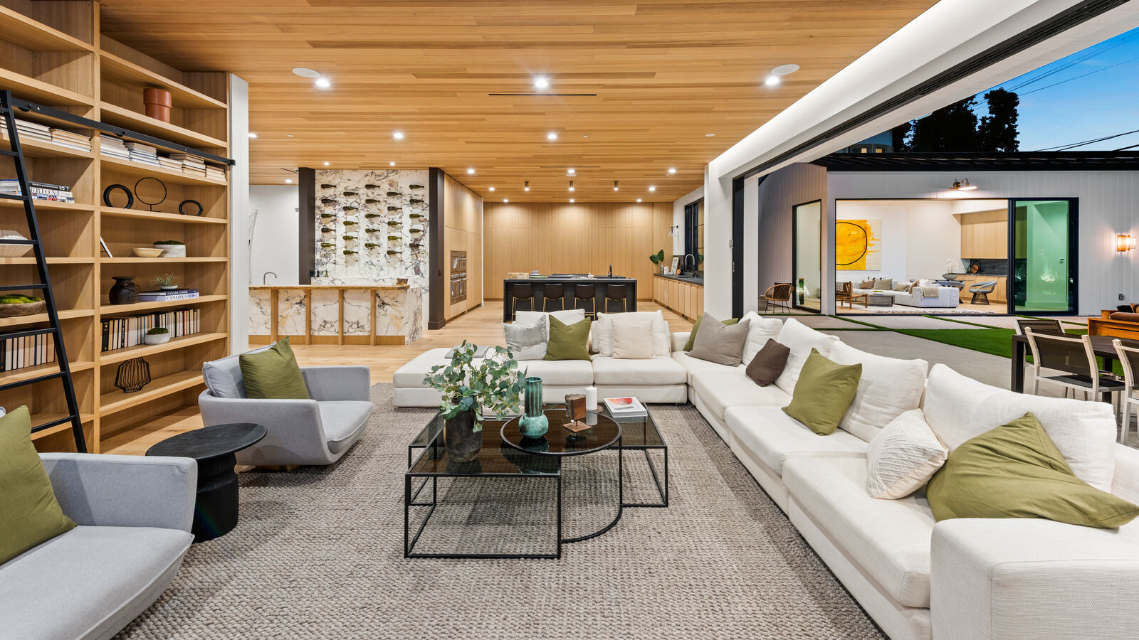 Luxury Van Nuys living room with white sectional and wood ceiling