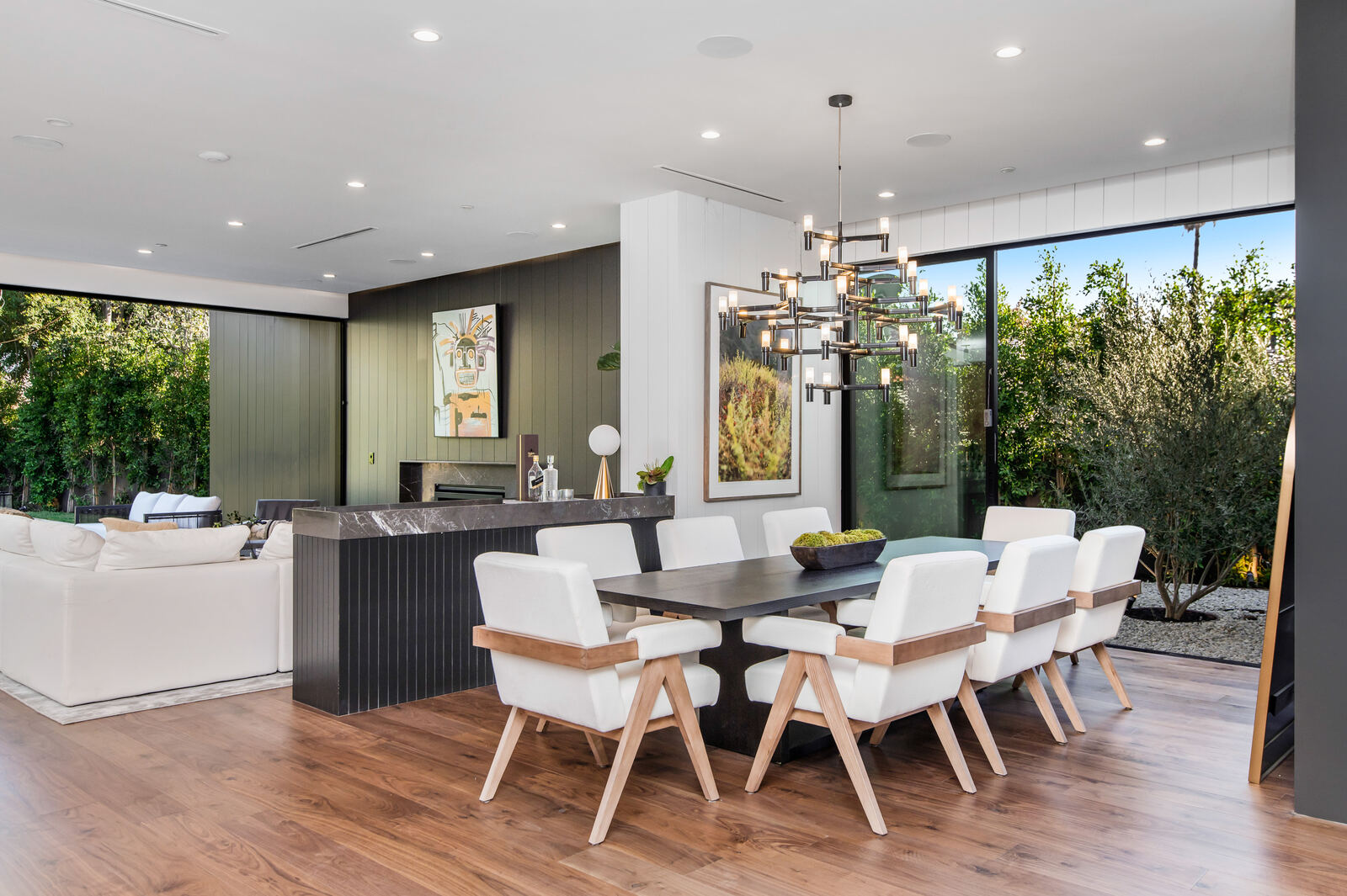 Modern Los Angeles dining room with black table and sculptural chandelier