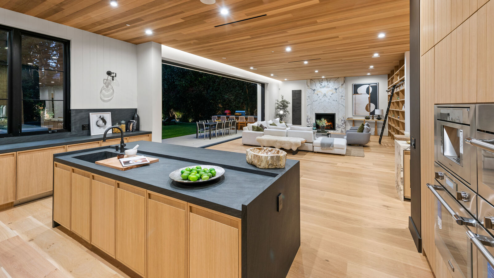 Open Los Angeles kitchen and living room overlooking an outdoor dining area